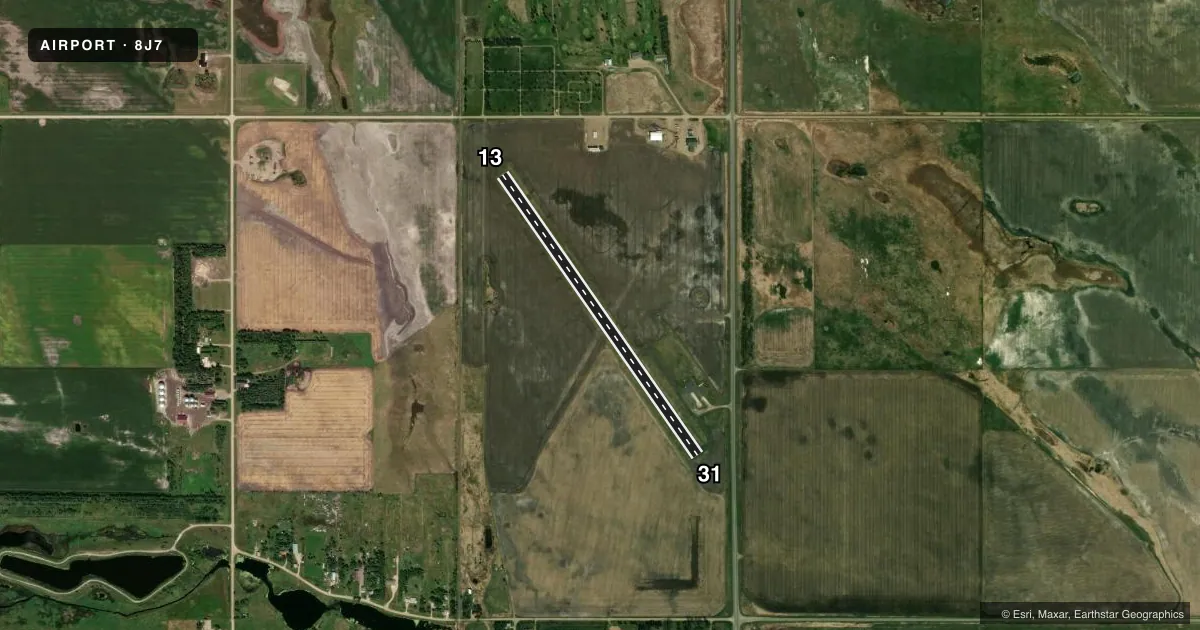 Top-down satellite sketch of 8J7 TOMLINSON FLD in NEW ROCKFORD, NORTH DAKOTA, showing runways 13/31 drawn to scale over Esri World Imagery