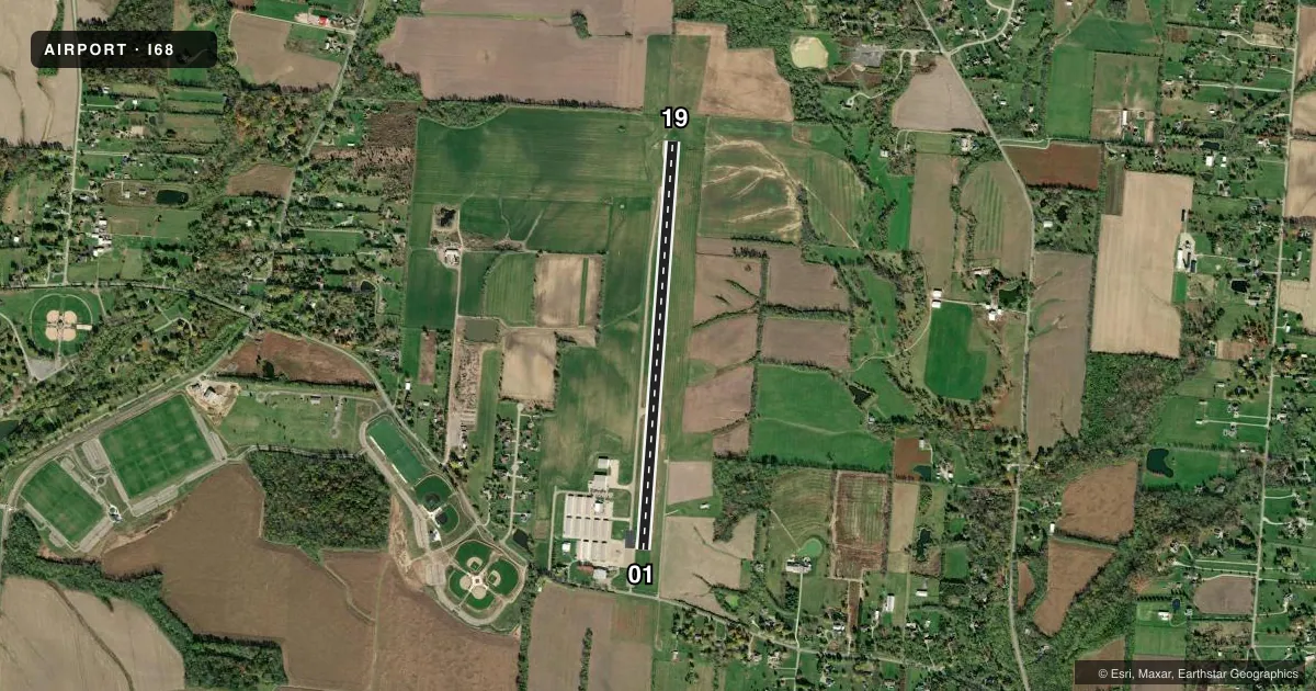 Top-down satellite sketch of I68 WARREN COUNTY/JOHN LANE FLD in LEBANON, OHIO, showing runways 01/19 drawn to scale over Esri World Imagery