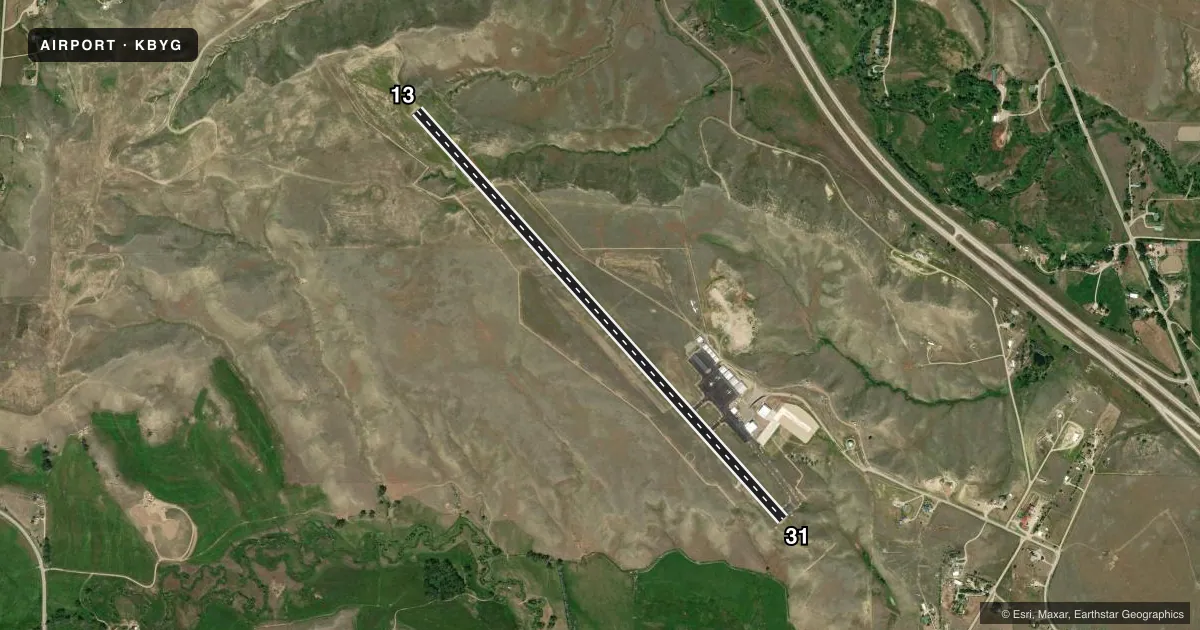 Top-down satellite sketch of KBYG JOHNSON COUNTY in BUFFALO, WYOMING, showing runways 13/31 drawn to scale over Esri World Imagery