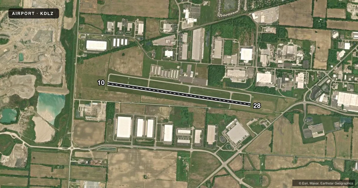 Top-down satellite sketch of KDLZ DELAWARE MUNI/JIM MOORE FLD in DELAWARE, OHIO, showing runways 10/28 drawn to scale over Esri World Imagery