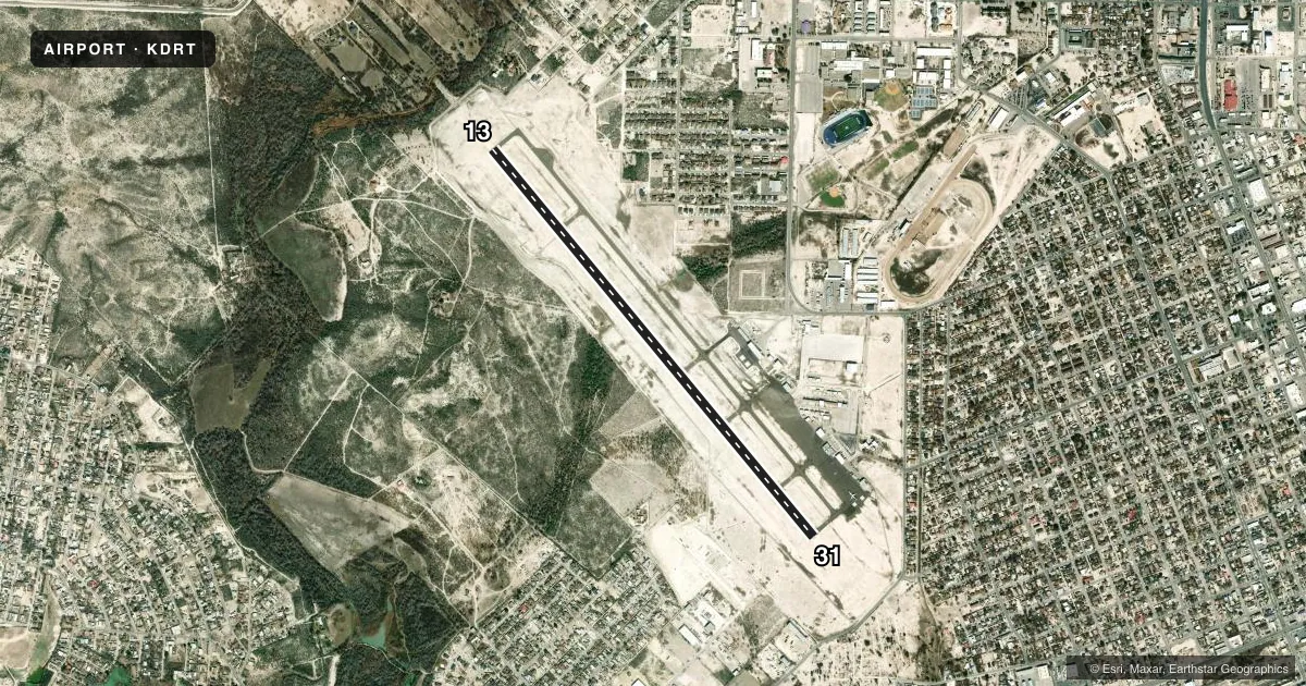 Top-down satellite sketch of KDRT DEL RIO INTL in DEL RIO, TEXAS, showing runways 13/31 drawn to scale over Esri World Imagery