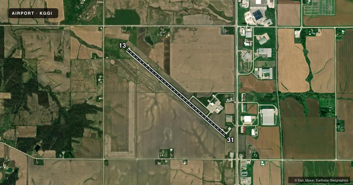 Top-down satellite sketch of KGGI GRINNELL RGNL in GRINNELL, IOWA, showing runways 13/31 drawn to scale over Esri World Imagery