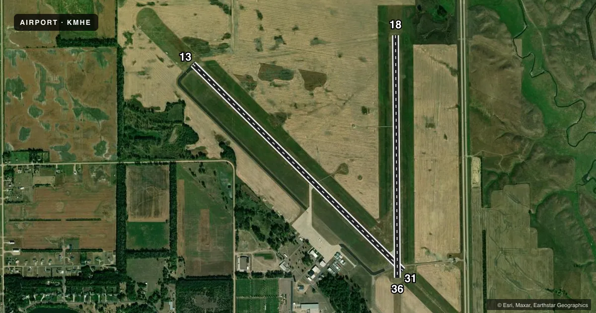 Top-down satellite sketch of KMHE MITCHELL MUNI in MITCHELL, SOUTH DAKOTA, showing runways 13/31, 18/36 drawn to scale over Esri World Imagery