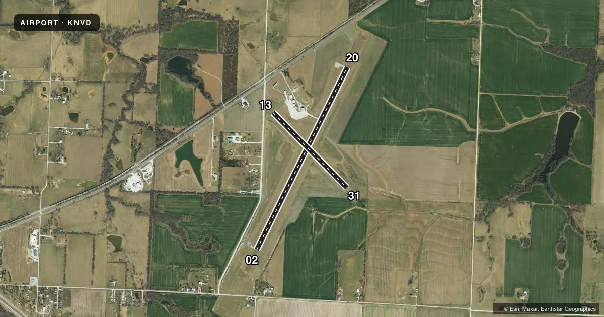 Top-down satellite sketch of KNVD NEVADA MUNI in NEVADA, MISSOURI, showing runways 02/20, 13/31 drawn to scale over Esri World Imagery