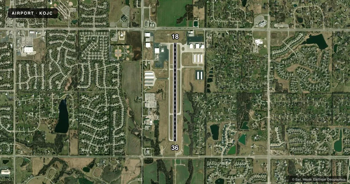 Top-down satellite sketch of KOJC JOHNSON COUNTY EXEC in OLATHE, KANSAS, showing runways 18/36 drawn to scale over Esri World Imagery