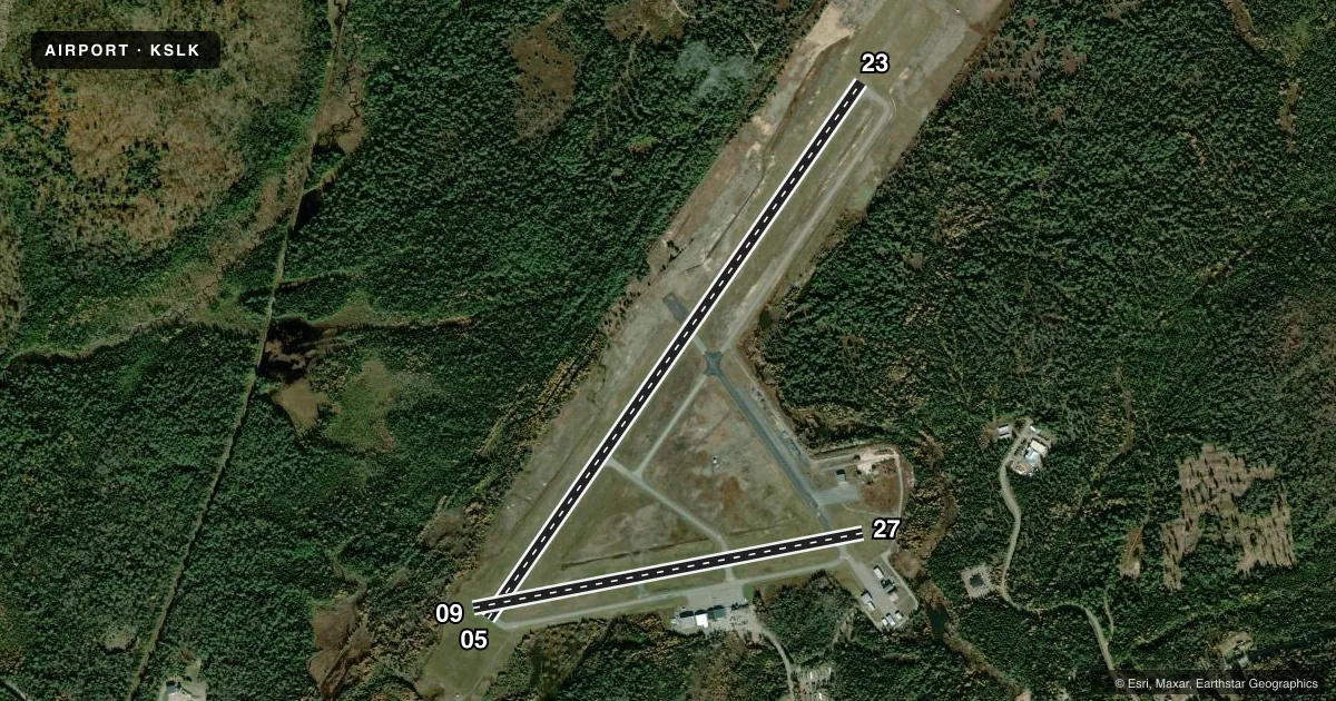 Top-down satellite sketch of KSLK ADIRONDACK RGNL in SARANAC LAKE, NEW YORK, showing runways 05/23, 09/27 drawn to scale over Esri World Imagery